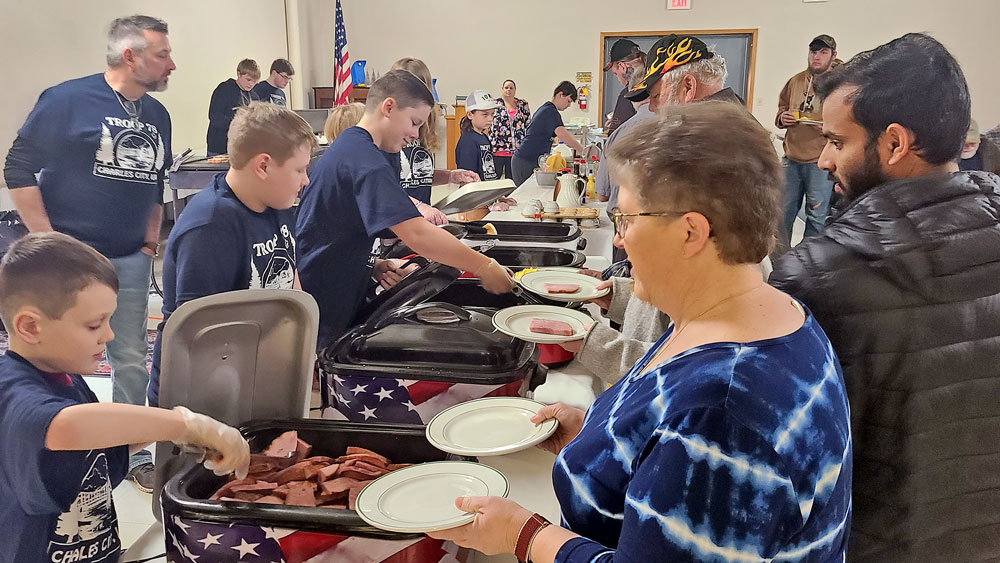 Scouts serve pancakes for breakfast fundraiser